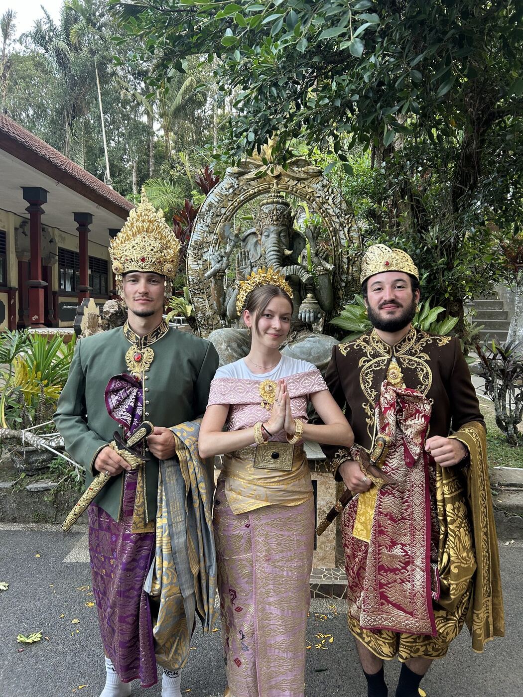 Voyageurs en tenue traditionnelle balinaise de mariage devant un temple